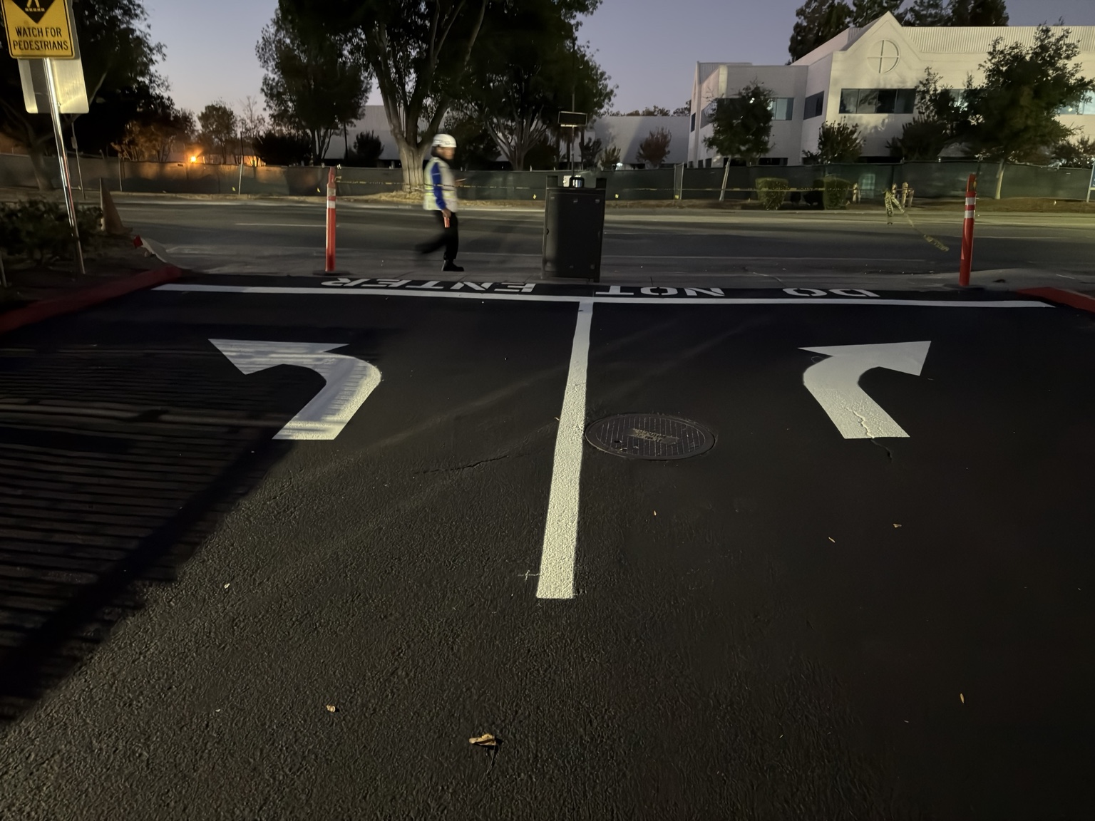 Turn-lane arrows and entry control markings on freshly striped asphalt