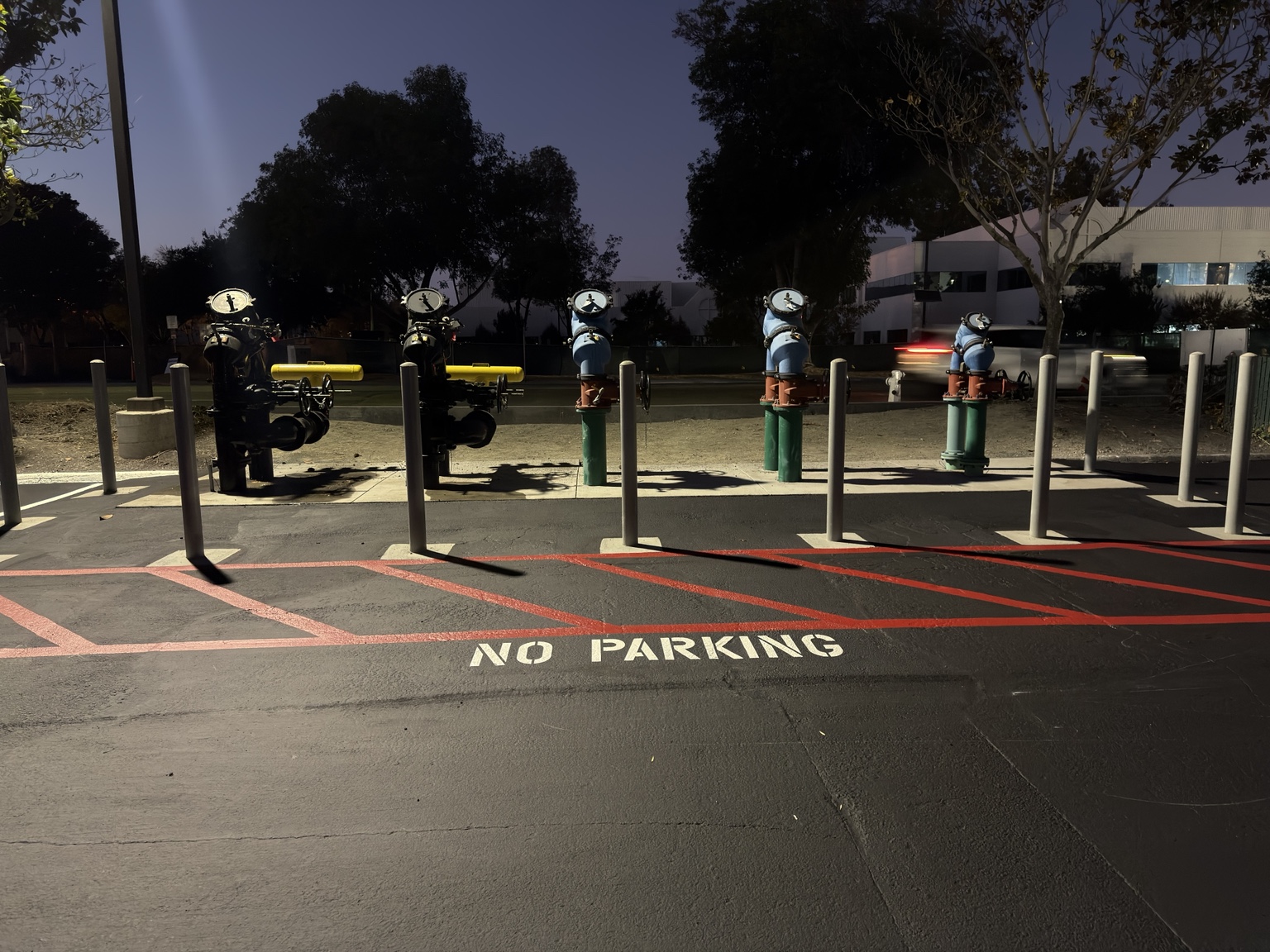 Red hatched no-parking zone next to utility equipment