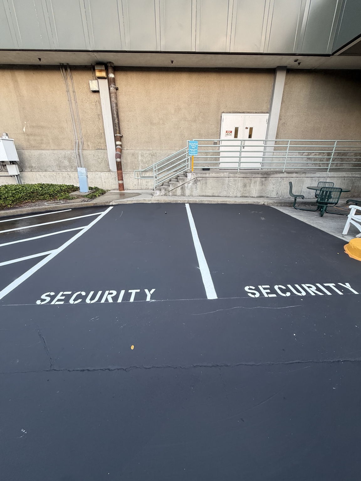 Freshly sealcoated lot with SECURITY stenciled stalls