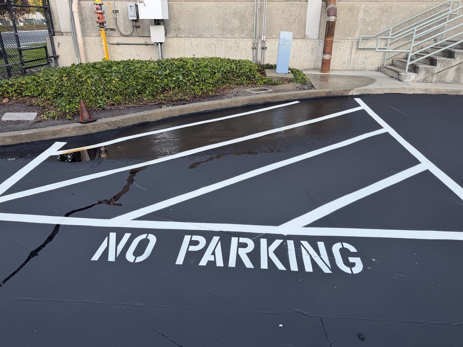 Sealcoated lot with a NO PARKING stencil and hatched area