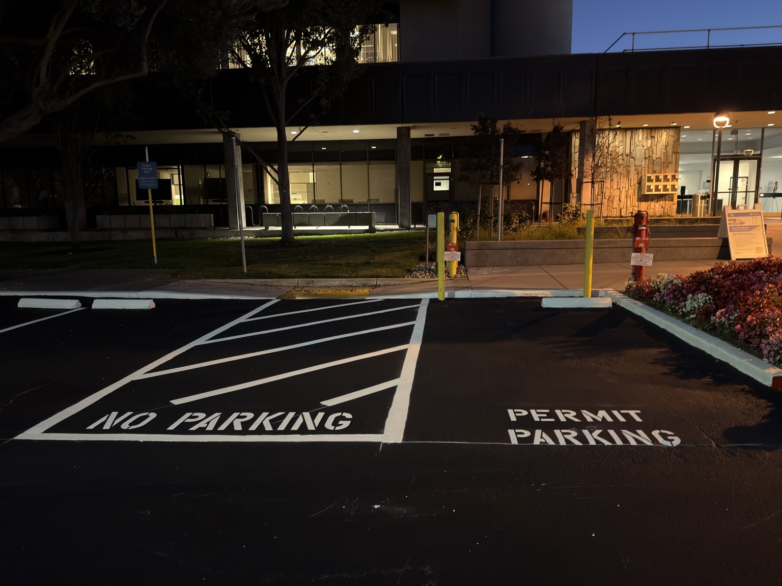 PERMIT PARKING stencil beside a hatched NO PARKING zone